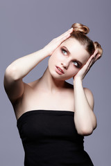 Obraz premium Young teen female beauty portrait with day makeup and bun hair style
