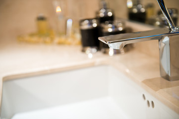 Closeup of sink and faucet in modern bathroom.