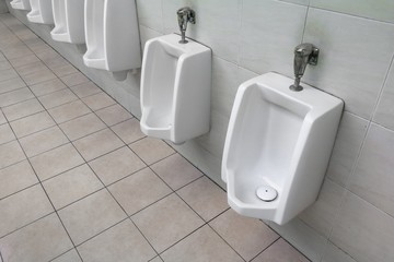 row of outdoor urinal men public toilet white urinals in men bathroom