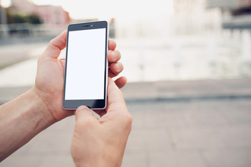 Hands holding blank screen smartphone with clipping path for screen