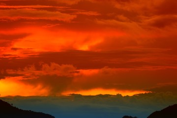 sunset in sky and cloud, beautiful colorful twilight time with mountain silhouette