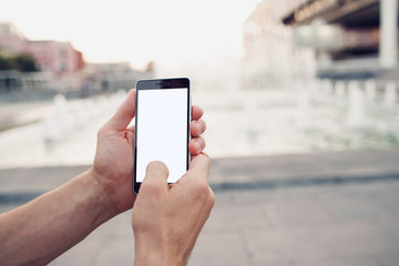 Taking photo with smartphone. Hands holding and touch on blank mobile with clipping path for screen.