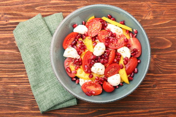 Tomato salad, mango and mozzarella with pomegranate seeds