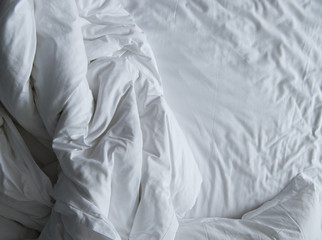 close up of messy bedding sheets and pillow