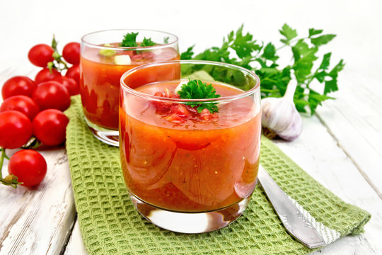 Soup tomato in two glasses on light board