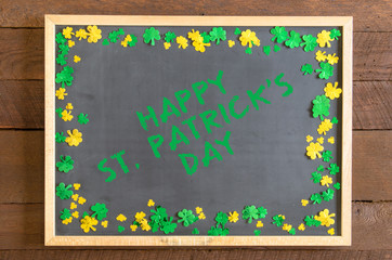 St Patrick's Day blackboard with gold and green shamrock confetti and message