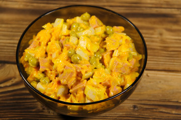 Mayonnaise salad with sausage, green pea, carrot and onion