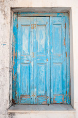 Old shabby greek door, weathered by the wind.