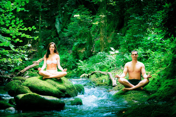Couple Doing Yoga By The River
