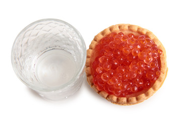Fish caviar and glass of vodka on white background