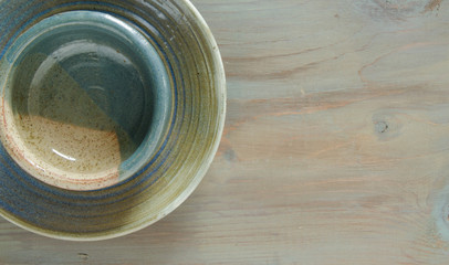 Pottery on a matching wooden background suitable for business card template