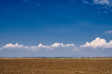 Ploughed soil under blue sky