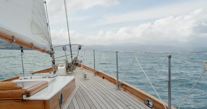Wooden luxury sailboat sailing over ocean in beautiful blue mediterranean sea