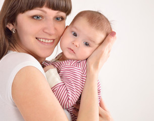 happy mother holds on hands of the newborn baby
