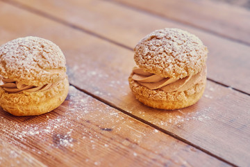 Baked sweet cakes on a wooden table.