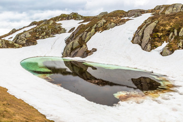 Norway mountain Frozen Lake landscape. Lysevegen scenic road in winter FV 500: Sirdal to Kjerag, Norway, Europe.