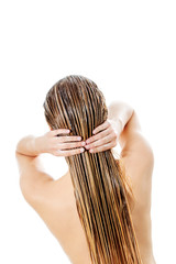 Photo of woman applying hair conditioner.