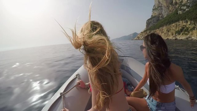 Beautiful girl friends travel on speed boat to paradise beach for relaxing nature tourist destination vacation discover explore 