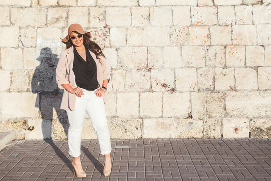Plus size model wearing fashion clothes in city street