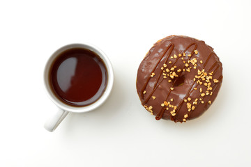 A cup of tea and donut with chocolate