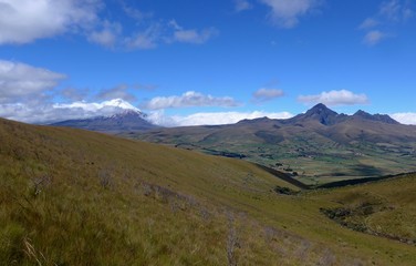 Fototapeta na wymiar Scenic view across open grasslands and farming country towards Cotopaxi Volcano in Ecuador