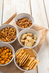 Pretzels in bowls on wooden table from above