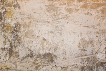 Old grungy wall with damaged plaster abstract horizontal background texture.