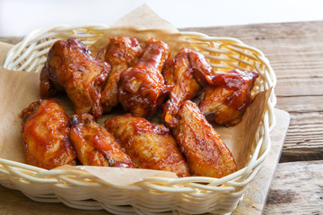 Fried chicken wings and legs in a tomato sauce