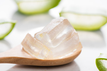 Aloe sliced and aloe vera gel on wooden spoon