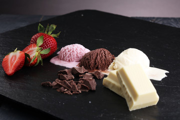 three scoops of ice cream - vanilla, strawberry and chocolate