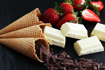 ice cream cones with white chocolate block and dark chocolate rasp and strawberries