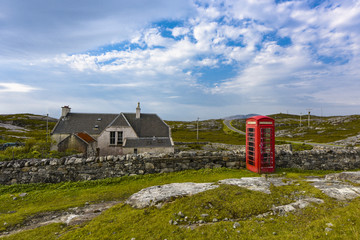 Red telephone box near an old building on Harris Islands