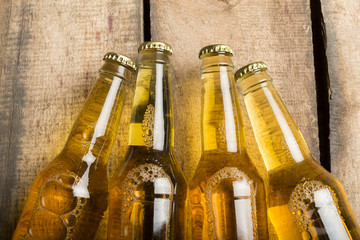 Beer bottles on a wooden table .