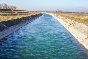 Irrigation canal between agricultural crops