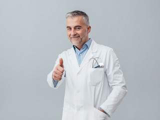 Cheerful doctor giving a thumbs up