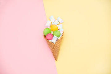 photo of tasty colorful marshmallows in waffle cone on the wonderful colorful background in pop art style