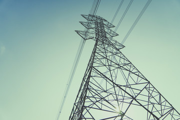 High voltage towers in the dark morning sky.