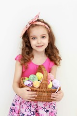 Adorable little girl playing with Easter eggs