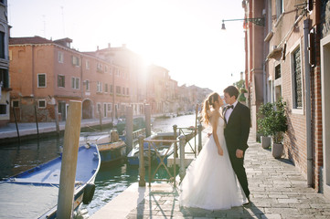 Tender bride and groom in a sunny day in Venice