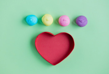 photo of tasty marshmallows and heart shaped box on the wonderful green background