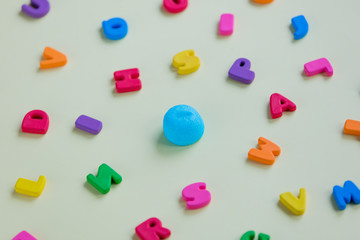 photo of tasty blue marshmallow and colorful letters on the wonderful white background
