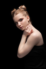 Fototapeta premium Young teen female beauty low key portrait with day makeup on black