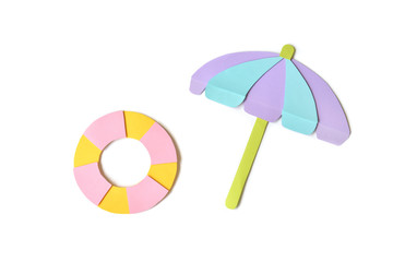 Sunshade and life ring paper cut on white background - isolated © niradj