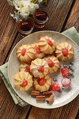 cinnamon cookies decorated with candied cherries