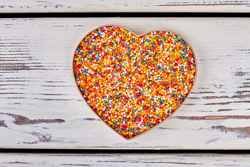 Heart box with sprinkle dots. Colorful sugar sprinkles. Saint Valentine present idea.