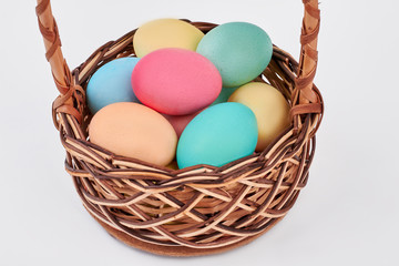 Easter egg basket isolated. Pile of painted chicken eggs.