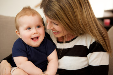 beautiful woman with her cute little son at home