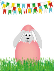 Easter bunny hatched from an egg. A rabbit is sitting in the grass