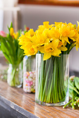 Yellow narcissuses bouquet in a glass vase
