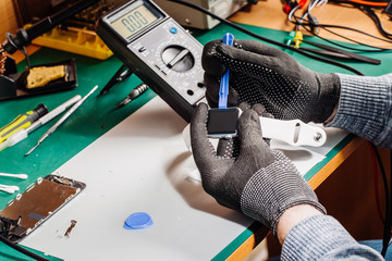 modern digital watch repair in engineer workshop.